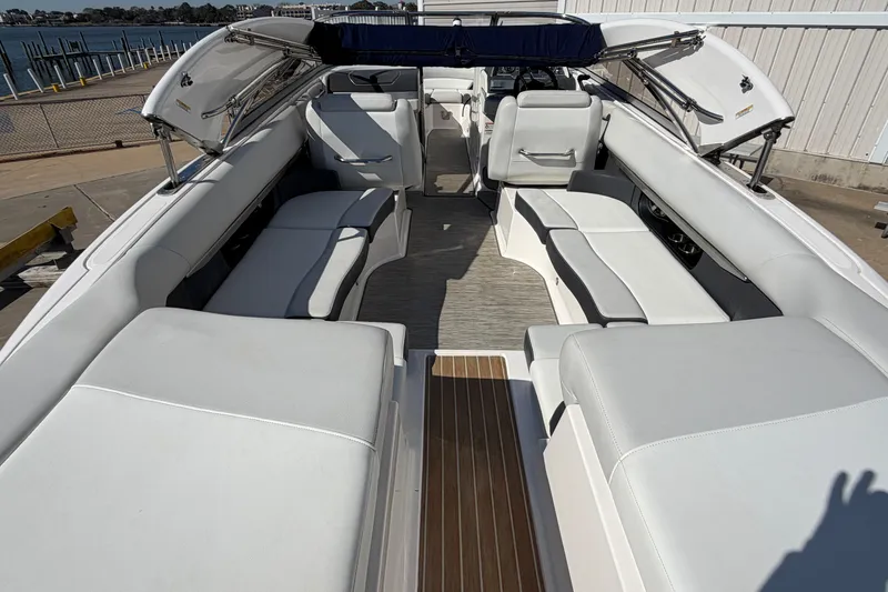 Slide: The Image of 2017 Regal 2700 ES Bowrider with spacious seating and sleek design at a dock. - 11