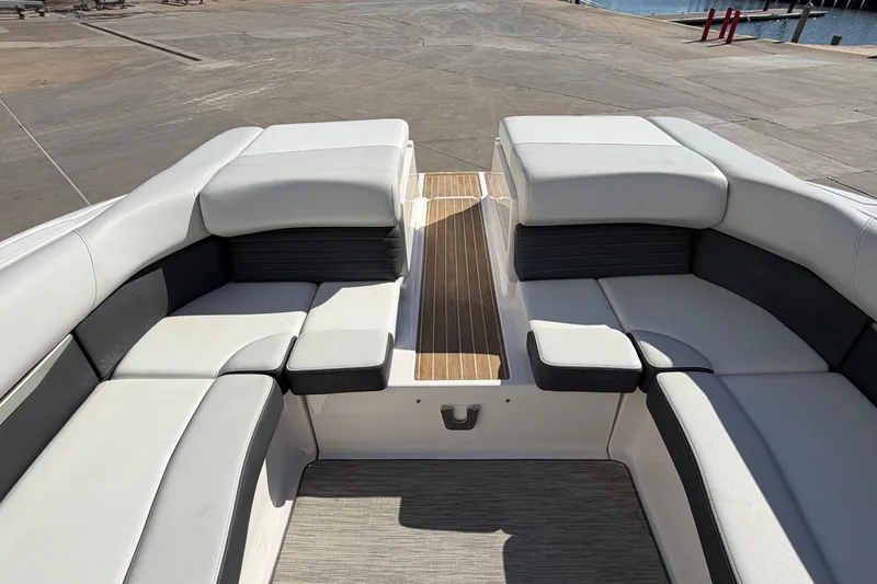Slide: The Image of 2017 Regal 2700 ES Bowrider interior with cushioned seating and wooden flooring. - 14