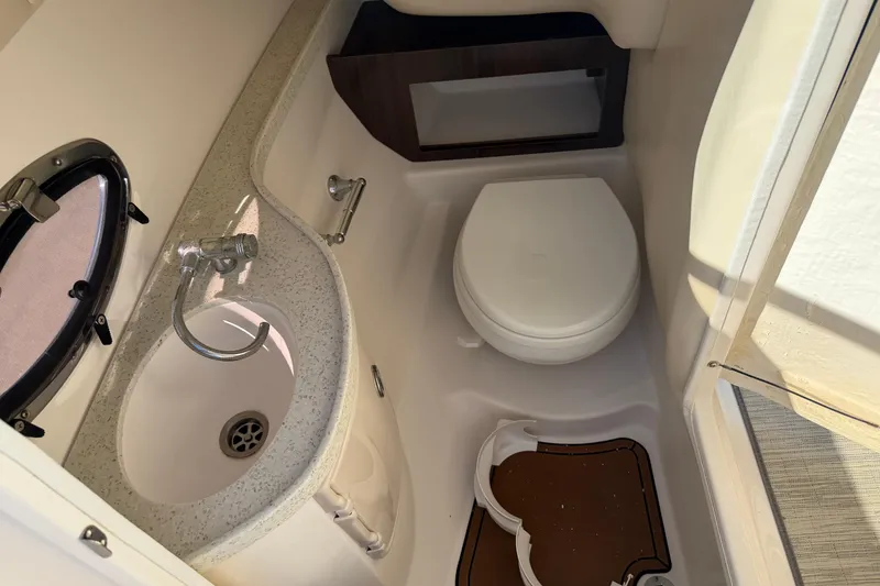 Slide: The Image of 2017 Regal 2700 ES Bowrider boat bathroom with sink and toilet. - 19
