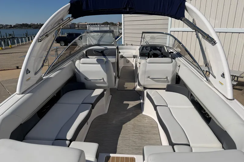 Slide: The Image of 2017 Regal 2700 ES Bowrider with spacious seating and sleek design at a marina. - 26
