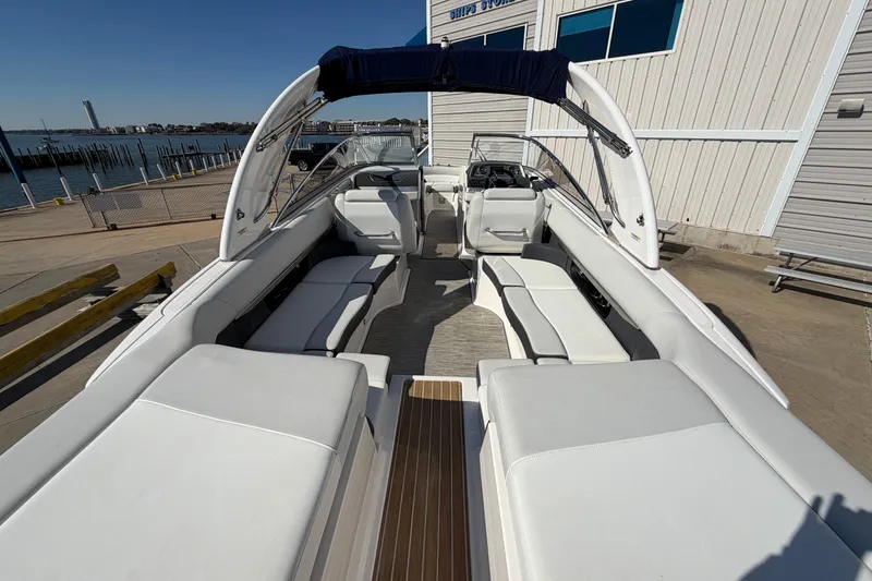 Slide: The Image of 2017 Regal 2700 ES Bowrider with spacious seating, docked near a waterfront building. - 27