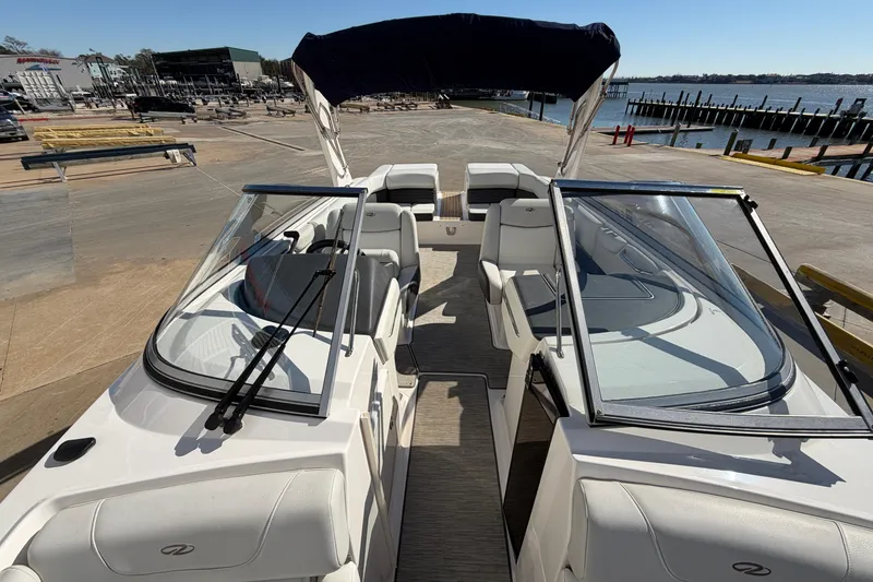 Slide: The Image of 2017 Regal 2700 ES Bowrider boat docked, featuring spacious seating and sleek design. - 28