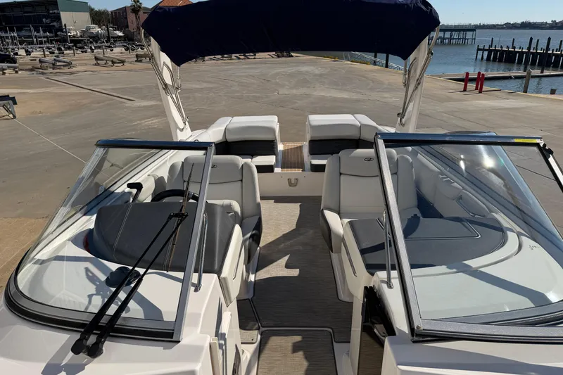 Slide: The Image of 2017 Regal 2700 ES Bowrider boat interior with seating and windshield, dockside view. - 29