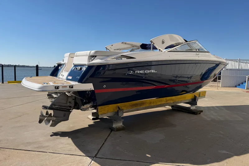 Slide: The Image of 2017 Regal 2700 ES Bowrider boat on dock, blue hull, sunny day. - 8