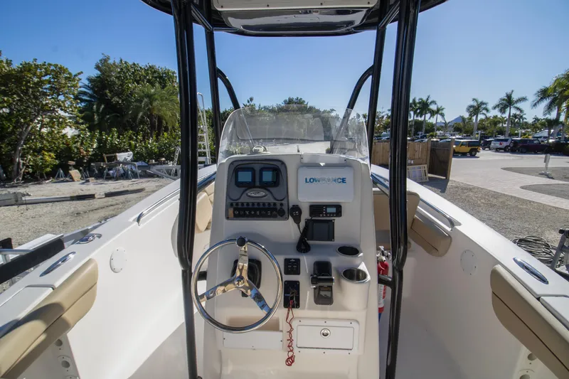 Slide: The Image of 2015 Tidewater 230 LXF boat console with steering wheel and navigation equipment. - 4