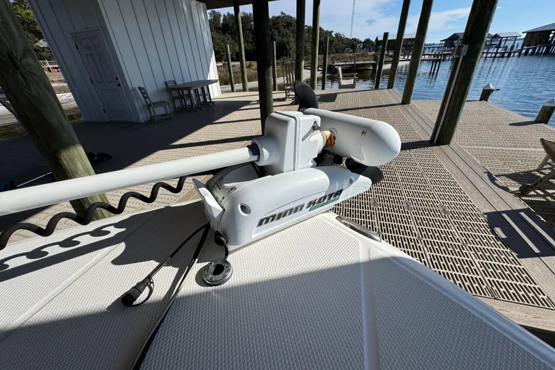Slide: The Image of Minn Kota trolling motor on 2015 Robalo 246 Cayman boat at dockside. - 13