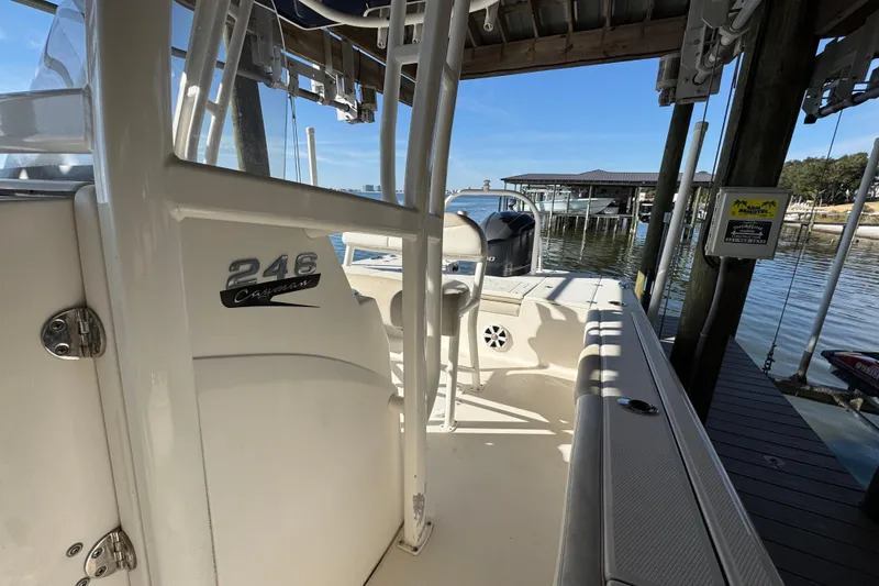 Slide: The Image of 2015 Robalo 246 Cayman boat docked, showcasing interior and seating area. - 17
