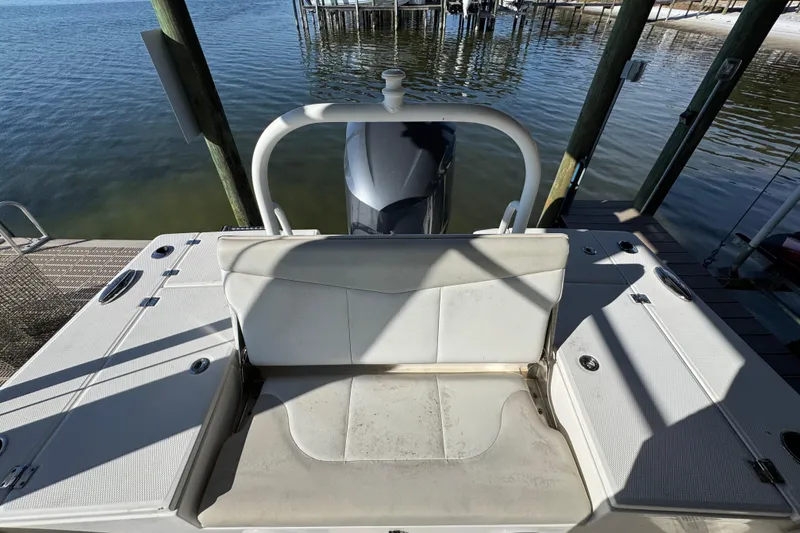 Slide: The Image of 2015 Robalo 246 Cayman boat with seating, docked by calm waters. - 26