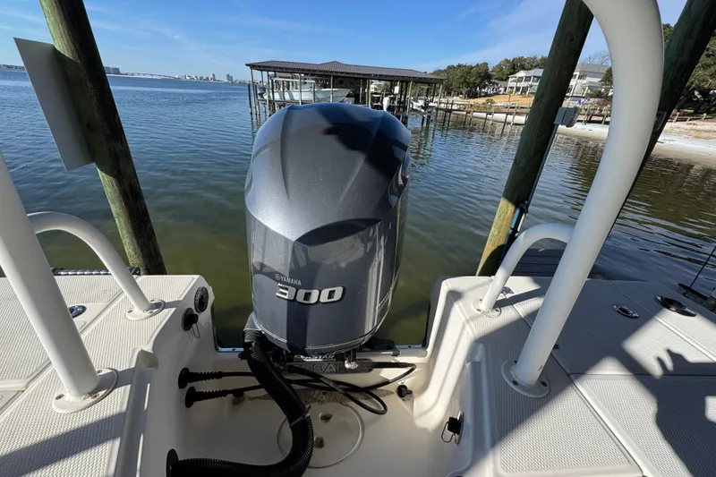 Slide: The Image of 2015 Robalo 246 Cayman boat with Yamaha 300 engine docked by the water. - 27