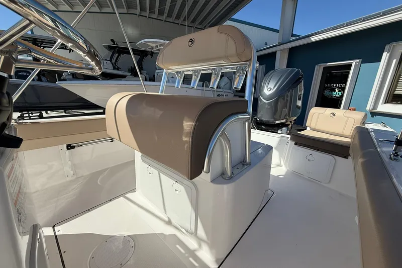 Slide: The Image of 2026 Edgewater 188CC boat interior with seating and console, under a covered area. - 6