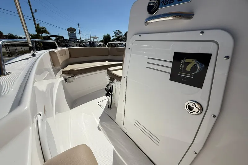 Slide: The Image of 2026 Edgewater 188CC boat interior with beige seating and storage compartment. - 8
