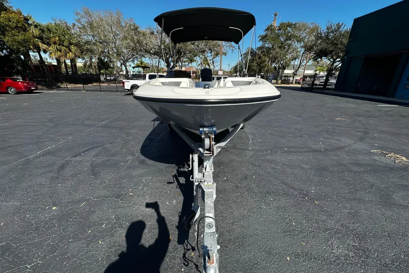 Slide: The Image of 2021 Bayliner Element E18 boat on trailer in parking lot, sunny day. - 3