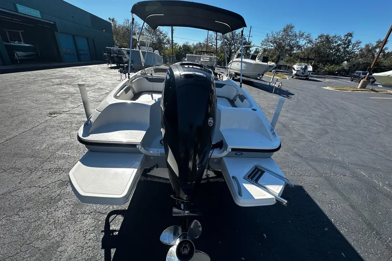 Slide: The Image of 2021 Bayliner Element E18 boat with outboard motor in a parking lot. - 4