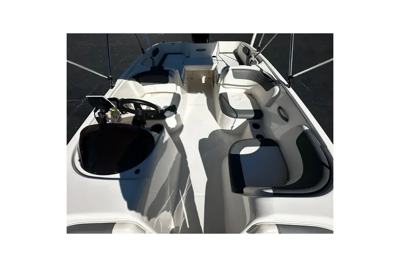 Slide: The Image of 2021 Bayliner Element E18 boat interior with seating and steering console. - 6