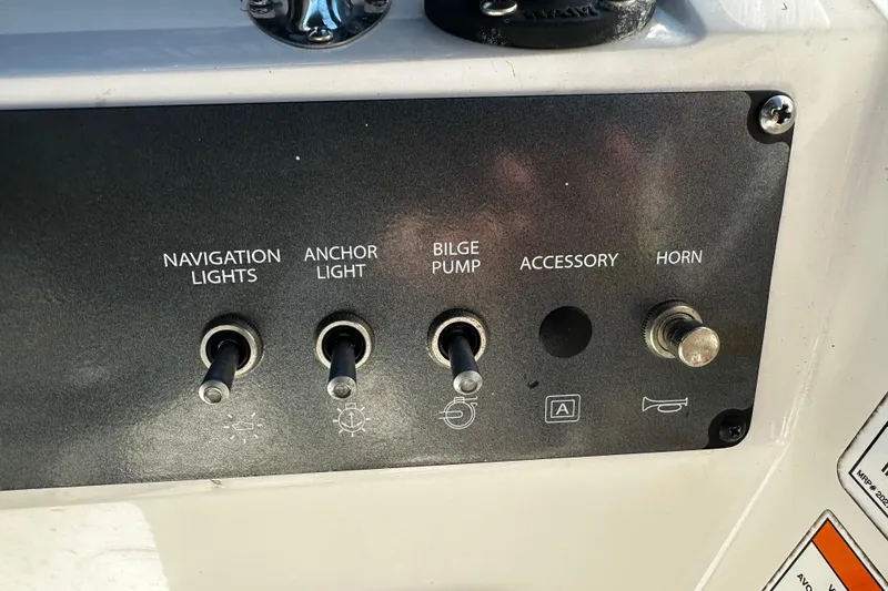 Slide: The Image of Control panel of a 2021 Bayliner Element E18 boat with labeled switches. - 9