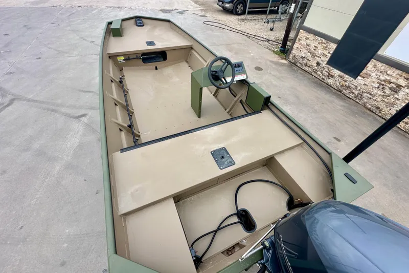 Slide: The Image of 2026 SeaArk 1652 Special boat interior with steering console and open deck layout. - 10