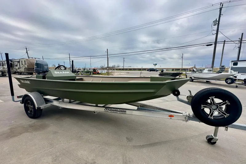 Slide: The Image of 2026 SeaArk 1652 Special boat on trailer, parked outdoors under cloudy sky. - 3