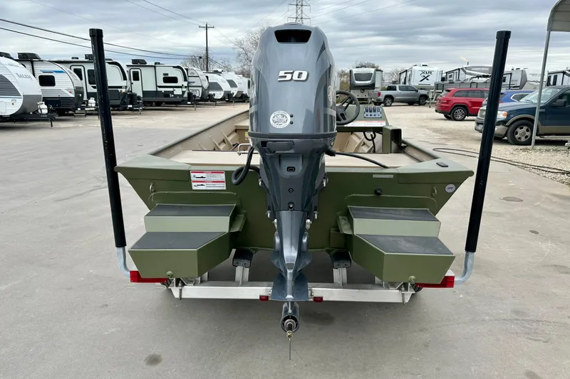 Slide: The Image of 2026 SeaArk 1652 Special boat with 50 HP motor, parked near RVs. - 5