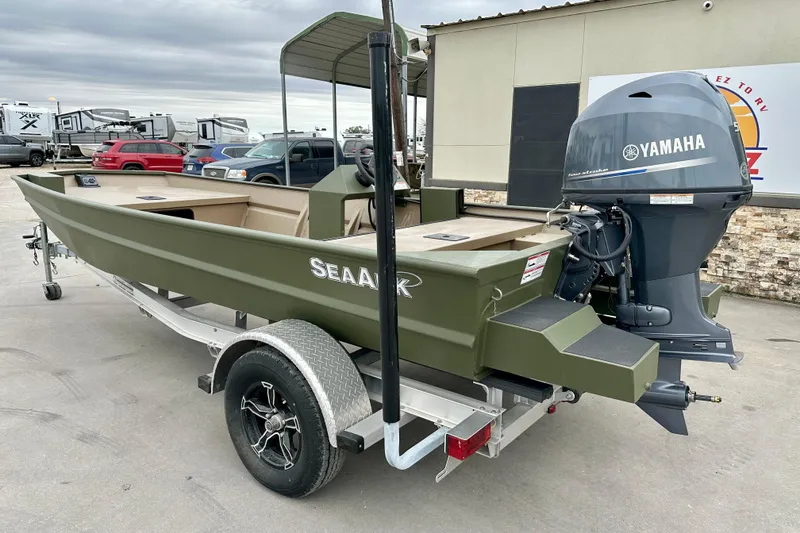 Slide: The Image of 2026 SeaArk 1652 Special boat with Yamaha motor on trailer, parked outdoors. - 6