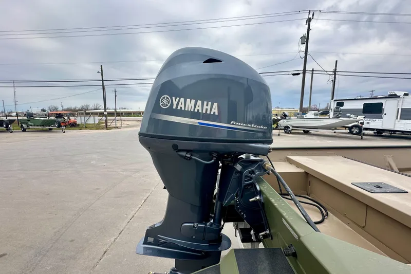 Slide: The Image of 2026 SeaArk 1652 Special boat with Yamaha four-stroke outboard motor in a parking lot. - 8
