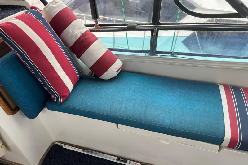 Slide: The Image of Cozy seating area on 1986 Ponderosa 42' boat with striped cushions. - 11