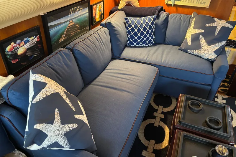 Slide: The Image of Blue sofa with starfish pillows in a cozy 1986 Ponderosa 42' interior. - 19