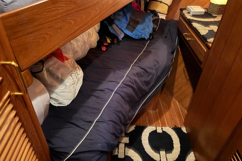 Slide: The Image of Cozy cabin interior of 1986 Ponderosa 42' boat with wooden furnishings and blue bedding. - 22