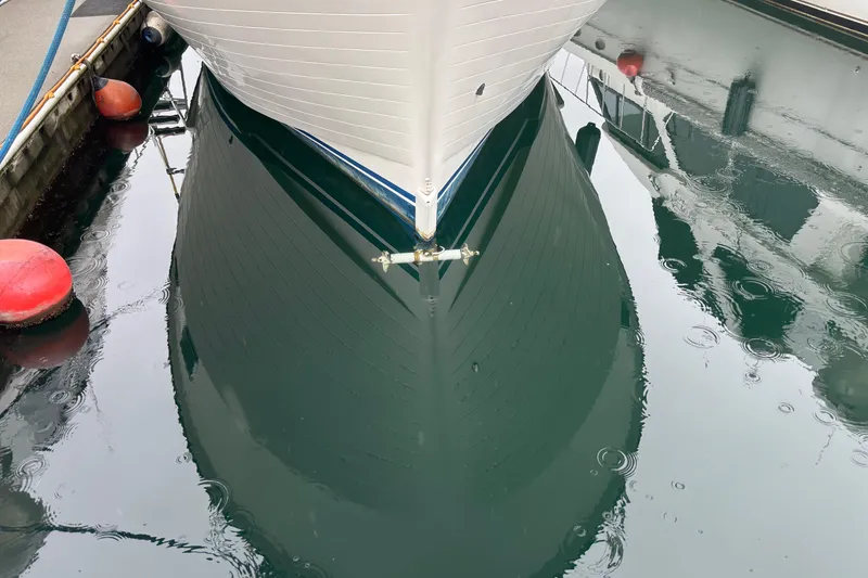 Slide: The Image of Bow of 1986 Ponderosa 42' boat reflected in calm marina water. - 33