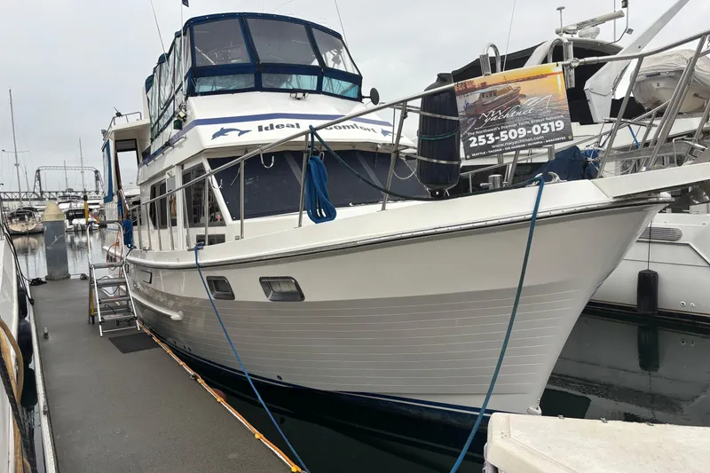 Slide: The Image of 1986 Ponderosa 42' yacht docked at marina, featuring sleek design and spacious deck. - 4