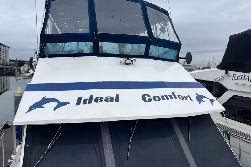 Slide: The Image of 1986 Ponderosa 42' boat named "Ideal Comfort" docked at a marina. - 5