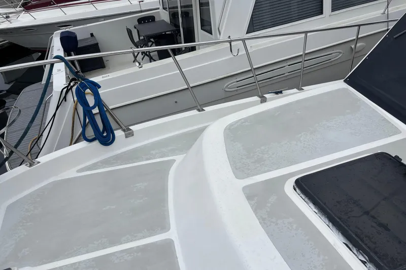 Slide: The Image of 1986 Ponderosa 42' yacht deck with railing and coiled blue rope. - 6