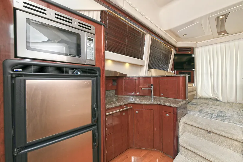 Slide: The Image of Interior of 2008 Sea Ray 44 Sedan Bridge with kitchen and stairs. - 27
