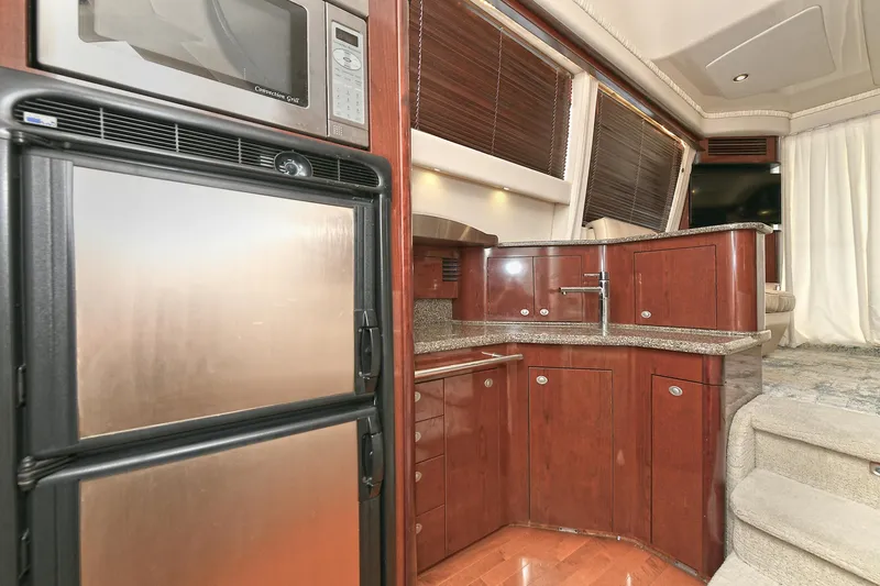 Slide: The Image of Interior of 2008 Sea Ray 44 Sedan Bridge with kitchen and stairs. - 29