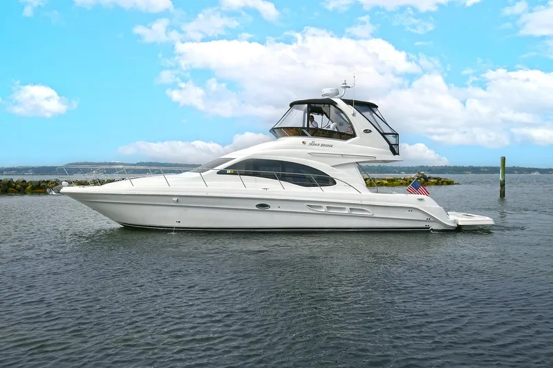 Slide: The Image of 2008 Sea Ray 44 Sedan Bridge on calm water. - 3