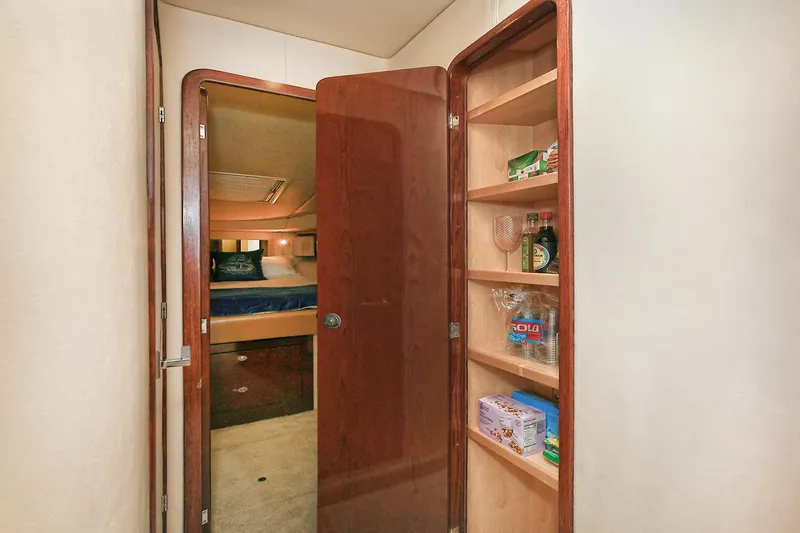 Slide: The Image of Interior of 2008 Sea Ray 44 Sedan Bridge with shelf and sleeping area. - 46