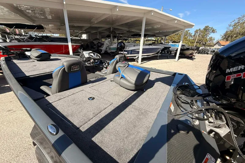 Slide: The Image of 2026 Ranger RT188P fishing boat with dual seats and powerful engine, parked under a canopy. - 4