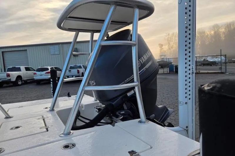 Slide: The Image of 2014 Hewes Redfisher 18 boat with Yamaha outboard motor in a marina setting. - 3