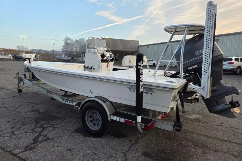 Slide: The Image of 2014 Hewes Redfisher 18 boat on trailer, parked outdoors, with Yamaha outboard motor. - 4