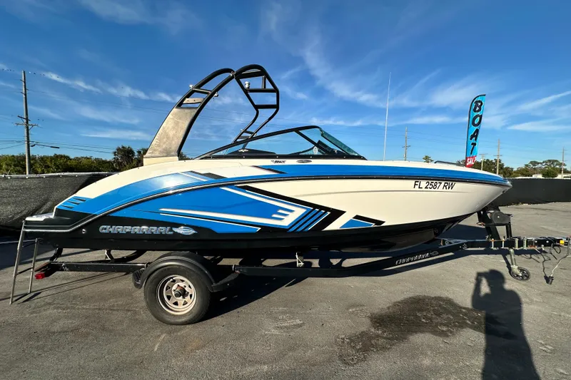 Slide: The Image of 2017 Chaparral Vortex 203 VRX boat on trailer, blue and white design. - 1