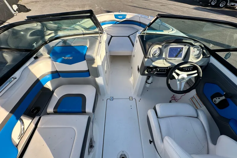 Slide: The Image of 2017 Chaparral Vortex 203 VRX boat interior with blue and white seating, modern dashboard. - 15