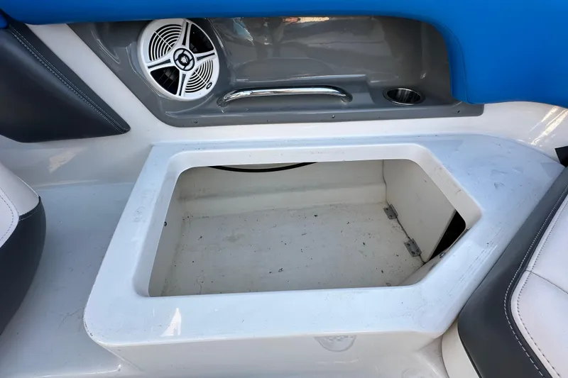 Slide: The Image of 2017 Chaparral Vortex 203 VRX boat interior storage compartment with speaker and cup holder. - 40