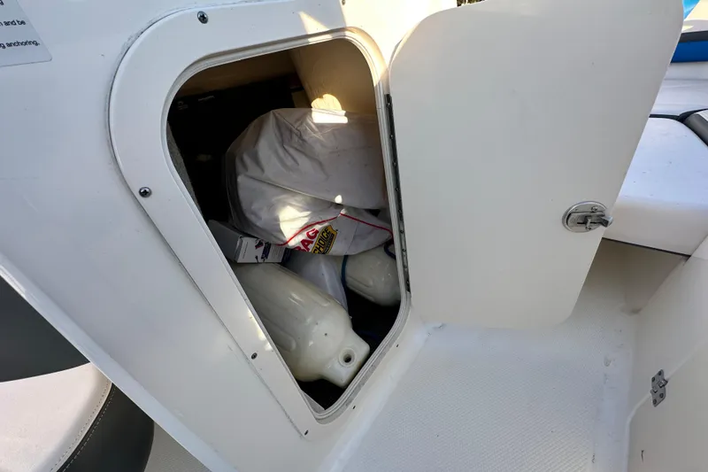 Slide: The Image of Storage compartment on a 2017 Chaparral Vortex 203 VRX boat, containing boating equipment. - 62