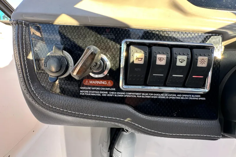 Slide: The Image of Control panel of 2017 Chaparral Vortex 203 VRX boat with switches and warning label. - 80