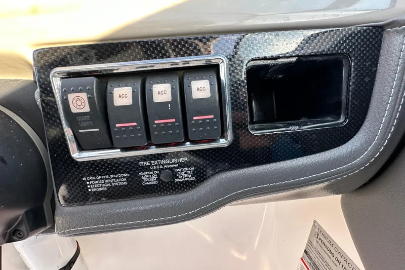 Slide: The Image of Control panel of 2017 Chaparral Vortex 203 VRX boat with switches and fire extinguisher instructions. - 84