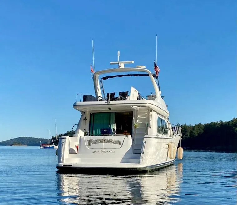 Slide: The Image of 2002 Bayliner 5788 yacht with Electronic Cummins QSMs on calm water. - 1