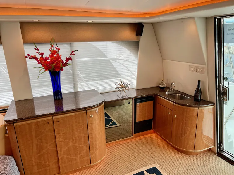 Slide: The Image of Luxurious interior of 2002 Bayliner 5788 yacht with modern cabinetry and elegant decor. - 10
