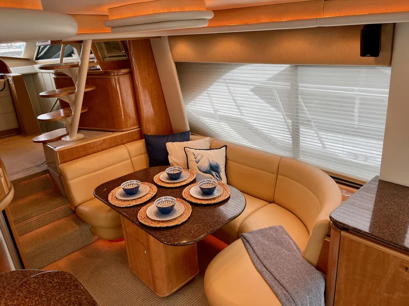 Slide: The Image of Luxurious 2002 Bayliner 5788 yacht interior with elegant dining area and modern decor. - 11