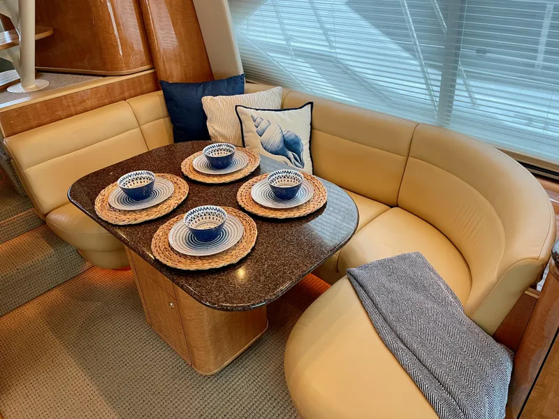Slide: The Image of Luxurious dining area in 2002 Bayliner 5788 yacht with elegant table setting. - 12