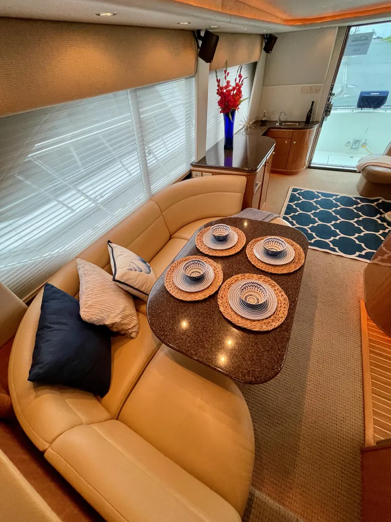 Slide: The Image of Luxurious interior of 2002 Bayliner 5788 yacht with dining area and modern decor. - 14