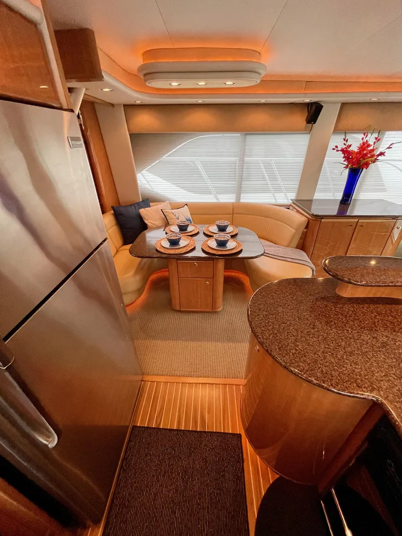 Slide: The Image of 2002 Bayliner 5788 yacht interior with dining area and modern kitchen. - 15